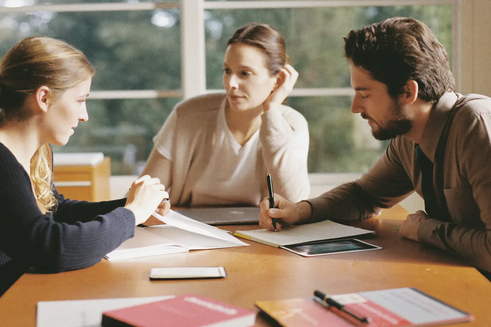 An advisor working through a plan with a couple at a bright table